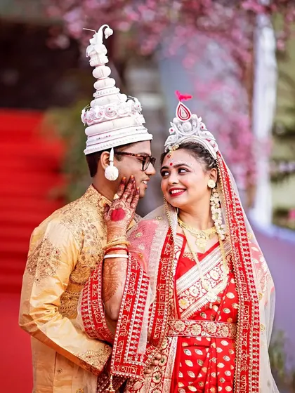 An intimate moment between a Bengali bride and groom, capturing the gentle connection that tells their story. I specialize in finding these quiet interactions amidst the wedding day chaos.