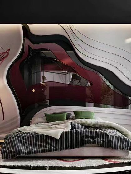 This is one of our most avant-garde bedroom designs, featuring a custom-made, fluid headboard with layers of black, red, and white. The entire setup, including the round bed, is designed to be a functional piece of art.