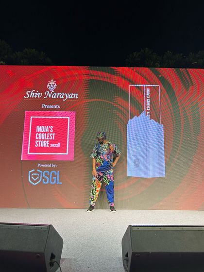 A solo shot of me on the grand stage for the Shiv Narayan Jewellers event. The professional setup and branding show the corporate-level quality of my performances.