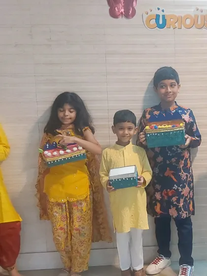 A group of children in traditional wear with their handcrafted festive boxes. Our workshops are a wonderful way to celebrate cultural occasions and create lasting memories.