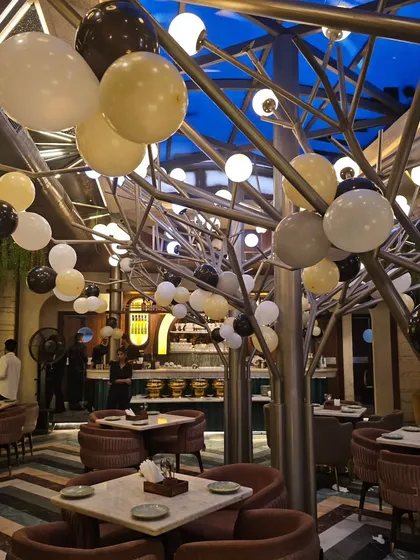 A shot of the venue for the 50th birthday, with balloons placed around the room to complement the main backdrop.