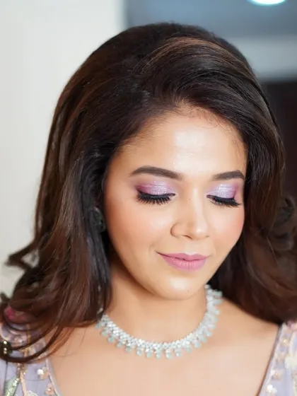 The focus here is on the dreamy, shimmering lilac eyeshadow. It's a perfect example of how a pop of color can elevate a look while still feeling elegant and sophisticated.