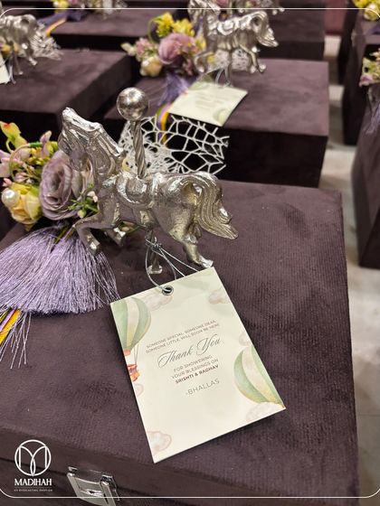 A detailed shot of a single hamper from the purple velvet collection. This image focuses on the silver-plated horse, the delicate tassel, and the custom 'Thank You' tag, showcasing the fine craftsmanship of each element.