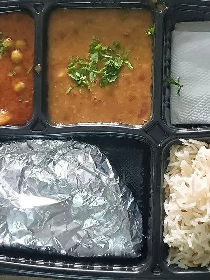 A simple, everyday thali with aloo matar and dal. This is the core of my tiffin service, providing nutritious and tasty meals on a daily basis.