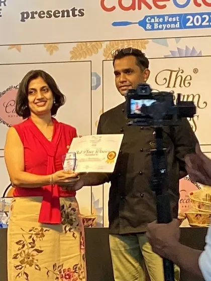 Here I am on stage receiving my third-place award at Cakeology 2022. It is always an honor to be recognized among so many talented artists.