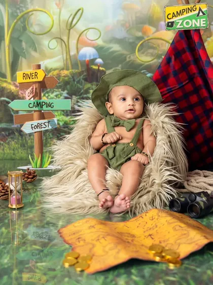 Ready for an adventure. This little explorer is all set for his camping-themed photoshoot, complete with a map, binoculars, and a cozy tent.