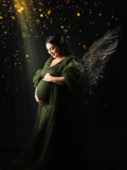 An angelic portrait in the green gown, with added light effects and golden wings. This turns a maternity photo into a magical piece of art, celebrating the miracle of life.