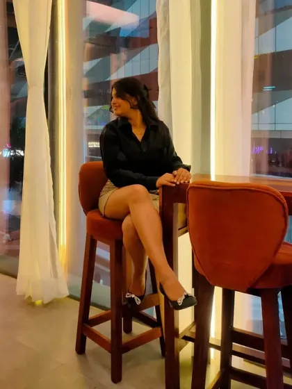 Another shot from the cafe, showing how this simple outfit looks sophisticated against the city lights. It's all about finding pieces that fit well and make you feel confident.