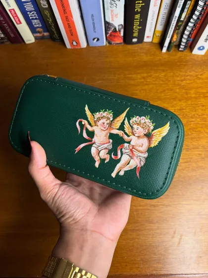 A different angle of the hand-painted cherub jewelry box.