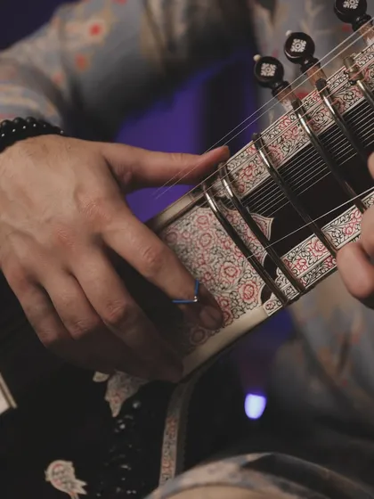 A detail shot of my hands and the sitar's beautiful inlay work. The craftsmanship of the instrument is a story in itself.