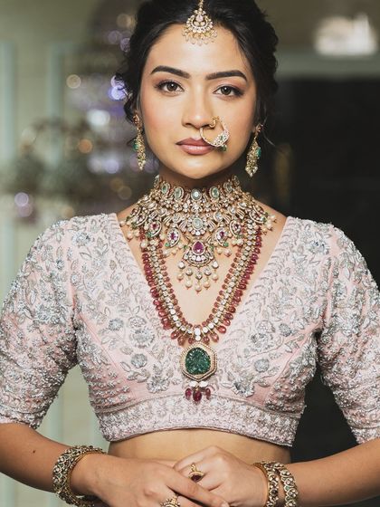 Twirl into a fairytale with this baby pink bridal lehenga. I designed it with intricate horse embroidery on the raw silk skirt and paired it with a heavily handworked blouse and a delicate net dupatta for a truly heavenly look.