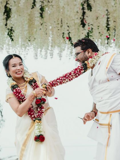 The playful tug of war during the garland exchange at a South Indian wedding. It's these fun, candid traditions that bring so much life and personality to a wedding album.