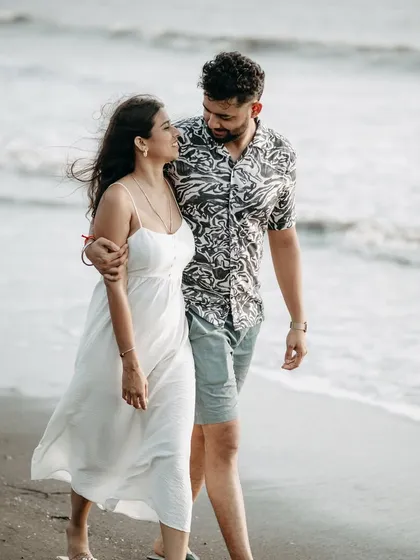 A quiet walk along the shoreline. This photo captures a simple, intimate moment, perfect for telling your love story.