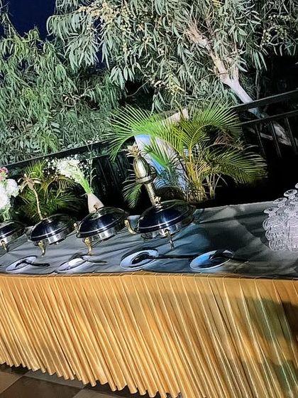 An outdoor buffet setup under the stars. We can cater in any location, bringing our full setup to create an unforgettable dining experience.