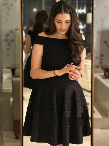 A different angle of the Alexander McQueen LBD, showing the delicate lace detail on the hem.