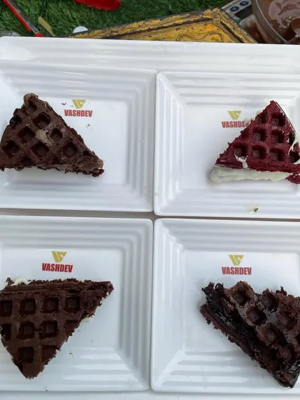 Four different types of our signature waffle sandwiches, each filled with delicious creams and sauces. They are easy for guests to hold and enjoy while mingling.