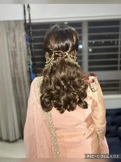 A closer look at a polished half-up hairstyle for a Roka ceremony. The hair is pulled back neatly and adorned with a beautiful pearl hair accessory, while the ends are styled into soft curls.
