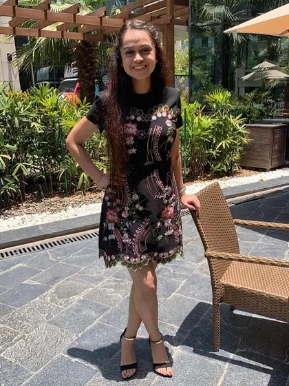 A close-up of the beautifully embroidered dress. The intricate floral pattern adds so much texture and visual interest, making it a standout piece for any daytime party or brunch.