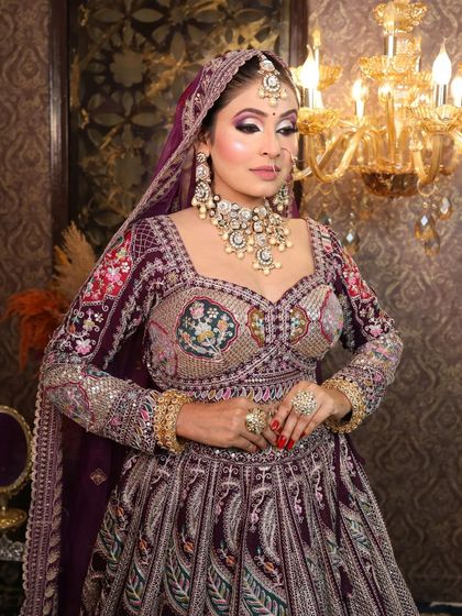 A portrait shot focusing on the intricate work of the blouse and the heavy bridal jewelry.