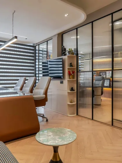 A view into one of the cabins through a fluted glass partition. This design choice allows for privacy while still letting light filter through, maintaining a sense of openness.