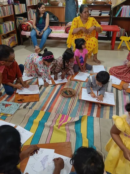 Another perspective of the children focused on their sea animal drawings.