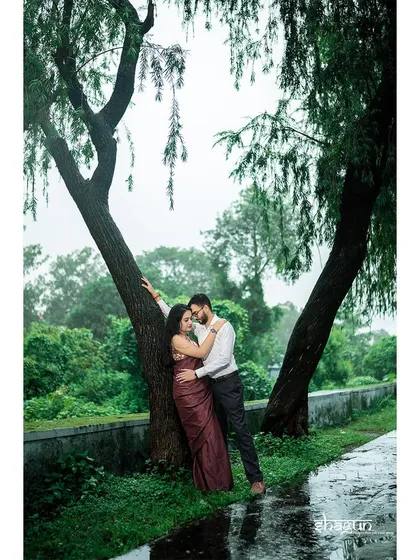 Finding shelter from the rain together under a tree. This intimate moment during a monsoon shoot is incredibly romantic and feels like a scene from a classic movie.