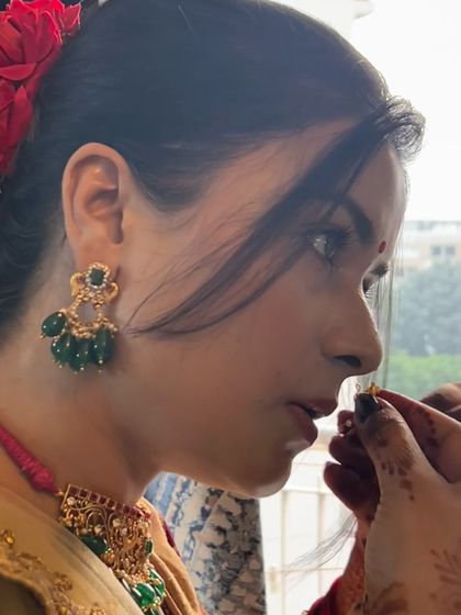 A candid moment showing a client wearing my green beaded choker and matching earrings. This close-up highlights the intricate gold work and the beautiful contrast of the emerald green beads.