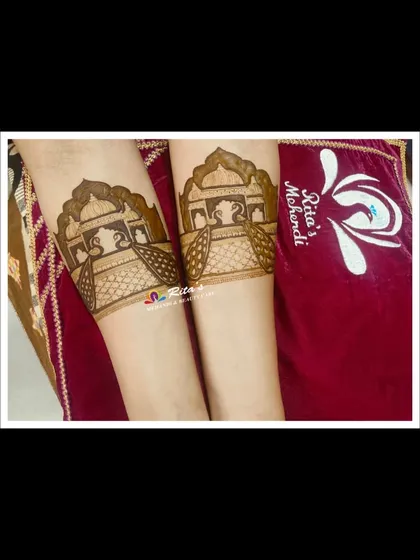 The startup bands on the arms, featuring traditional 'palki' or palanquin designs.