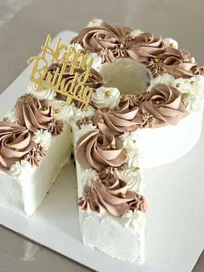 A sweet treat for a special someone. This "R" monogram cake is elegantly decorated with two tones of chocolate frosting and a "Happy Birthday" topper.