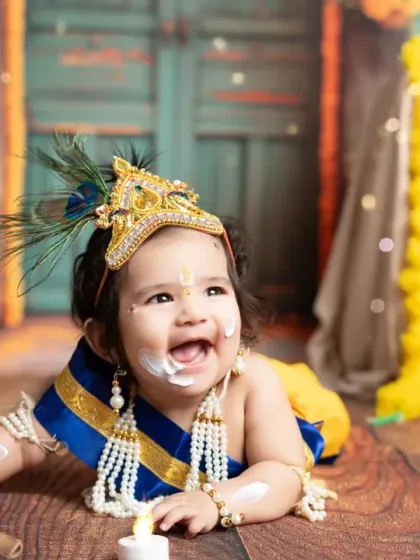 Capturing the playful spirit of a little one in our popular 'Little Krishna' themed photoshoot. This joyful moment, complete with a mischievous, buttery smile, showcases how I bring creative concepts to life for memorable child portraits.