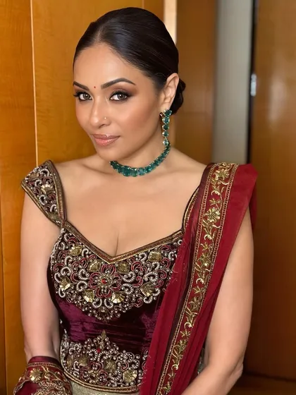 The final portrait of this stunning festive look. The combination of bold eyes, radiant skin, and a classic updo is the epitome of grace and style.