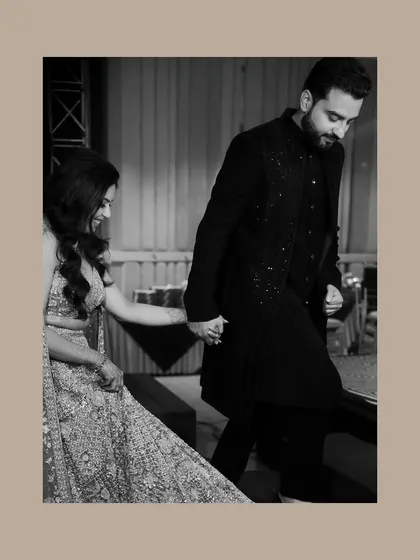 A black and white shot of the couple holding hands as they walk. This image focuses on their connection, creating a timeless and elegant pre-wedding portrait.