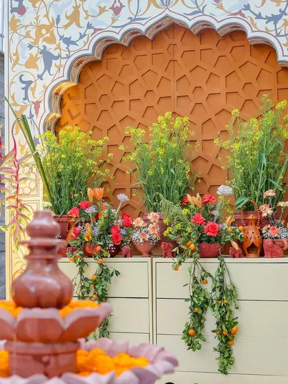 Another angle of the fountain and floral display, framed by the hand-painted Mughal-style arch. This composition highlights the layers of detail in the decor.