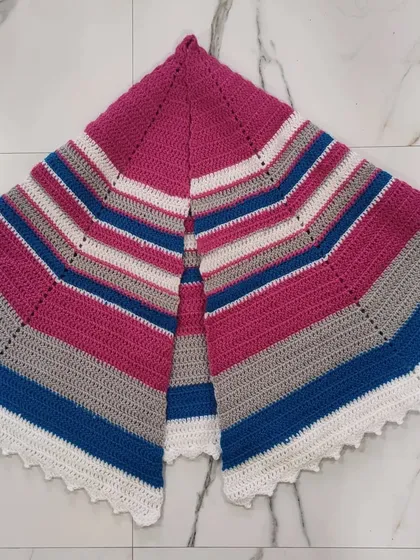 This fuschia, grey, and blue semi-circle shawl is another beautiful wrap project. The striped pattern is simple to create and the semi-circle shape drapes beautifully over the shoulders.