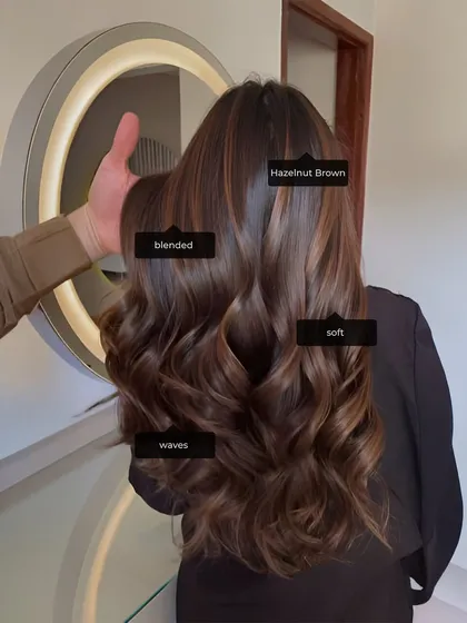 This hazelnut brown look showcases a soft, blended colour with beautiful waves. This is the kind of commercial, in-demand style we train our students to perfect.