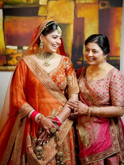 A candid photograph of a bride sharing a moment of pure laughter with her mother. Capturing these warm, genuine connections is central to our documentary style of family photography.