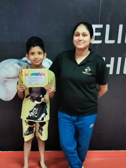 This young boy proudly holds his "Awesomeness" certificate, a fun reward for his great effort in class.