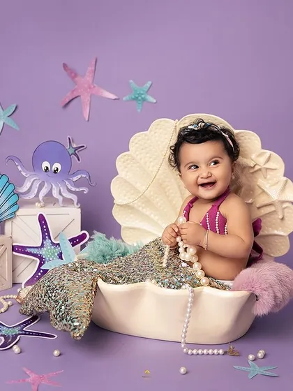 A wide view of our enchanting mermaid setup. The purple backdrop, handcrafted sea creatures, and sparkling details all come together to create a vibrant underwater world.