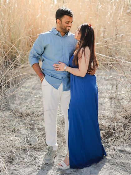 A sweet moment of a couple standing in a field of tall, dry grass, showcasing a different texture of the Dalhousie landscape.