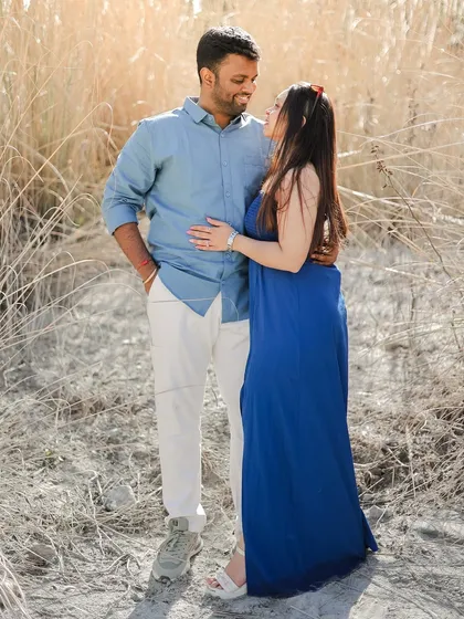 A sweet moment of a couple standing in a field of tall, dry grass, showcasing a different texture of the Dalhousie landscape.