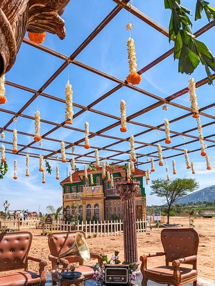 A beautifully decorated seating area at the Unnati launch, with hanging flowers and vintage-style furniture.