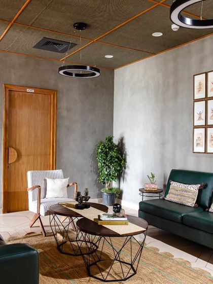 Another view of the lounge, showing the collage of Sufi dancer art, paying homage to Hyderabad's rich heritage. The design thoughtfully combines local culture with a modern, industrial framework.