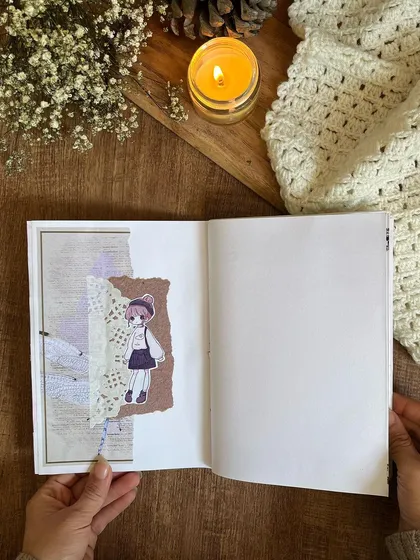A collage page featuring a cute illustration and textured paper from the custom journals.