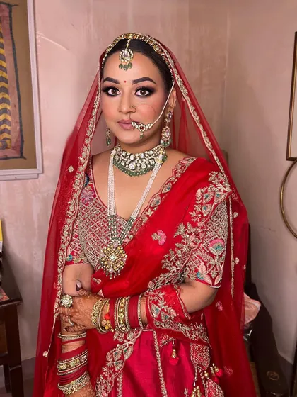 A beautiful bridal look for a dusky beauty. This makeup enhances her natural complexion with warm tones and defined eyes, creating a royal and timeless style.