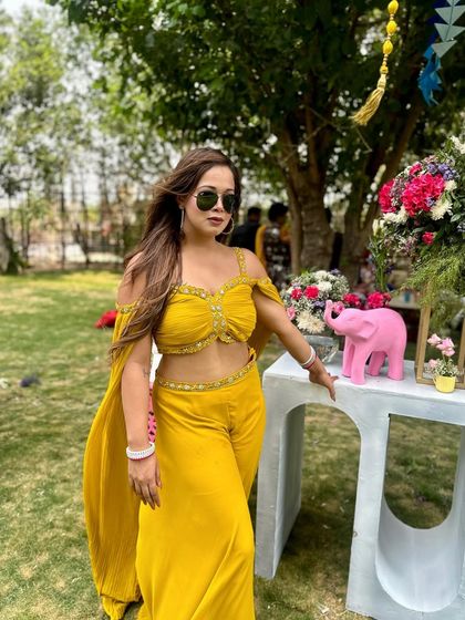 Soaked in yellow for a vibrant Haldi ceremony. This chic co-ord set with a flowing cape was both comfortable and stylish for a fun-filled day of hosting under the sun.