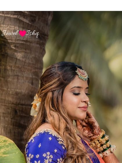 A serene portrait of the bride in her traditional Marathi engagement look, highlighting her Temple Jewellery maang tikka.
