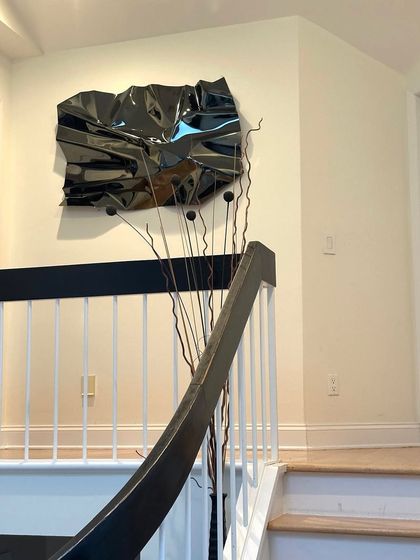 The placement of this black Meteor piece ensures it is a point of interest from multiple levels of the home.