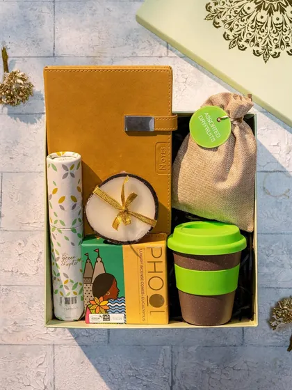 This eco-friendly Diwali hamper is perfect for sustainable gifting. It includes a reusable bamboo cup, a diary, a candle, and other thoughtful, green products.
