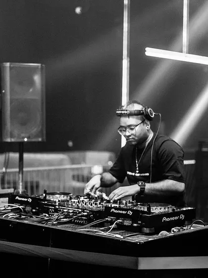 Locked in at the console. This black and white shot captures my focus during a deep progressive set at a club in Bangalore. It's all about the music and the journey.