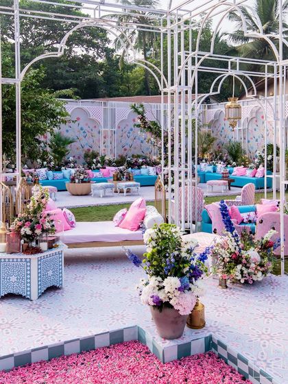 The 'Botanical Marrakesh' mehendi was held in a glasshouse structure we built from scratch. The space featured a central water body filled with petals, surrounded by cozy lounges that blended Moroccan-inspired prints with a fresh, botanical feel.